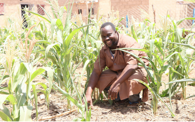 Pastor Emile shows the improved health of his field crops after implementing liquid fertilizer and planting stations. Emile has shared what he learned with more than 500 others.