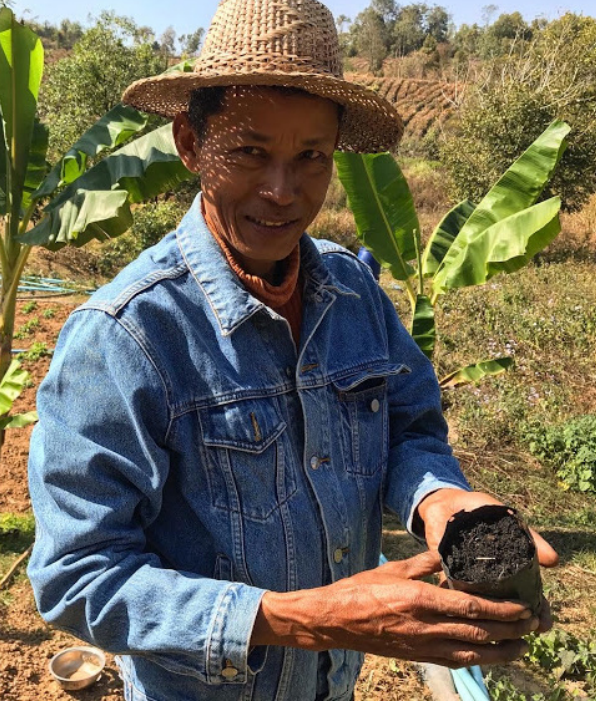Mr. Tuntun showing us the biochar he makes and uses to grow his fruit tree seedlings. He learned how to make biochar from an ECHO Asia training.