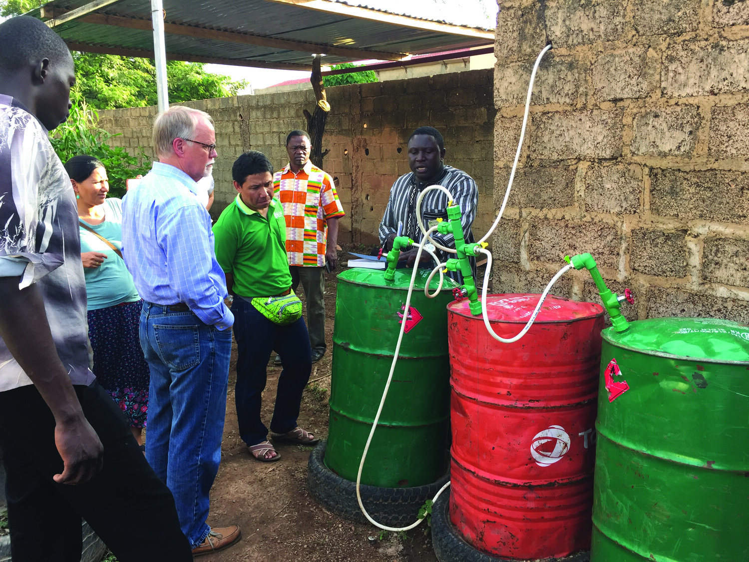 David Erickson in 2018 with staff from ECHO’s Regional Impact Centers
learning about biogas production in Burkina Faso, West Africa.