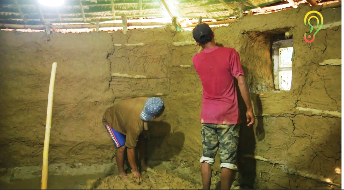 Saw Shiesho and his teammates build an insulated seed storage room out of bamboo and mud. Opposite: Saw Shiesho is interviewed in front of the completed appropriate technology seed bank.